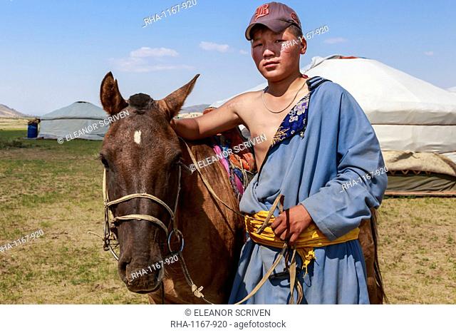 Portrait of nomad in deel with his horse, Nomad gers, Khogno Khan Uul Nature Reserve, Gurvanbulag, Bulgan, Northern Mongolia, Central Asia, Asia