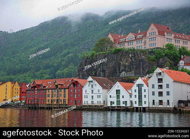 BERGEN, NORWAY - MAY 31, 2017: Old hansaetic wooden houses built in row at wharf of Bergen fjord are UNESCO World Heritage site and very popular for turists