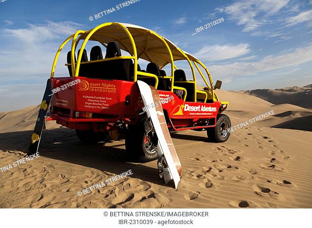 Dune buggy with boards for sandboarding in the desert near Huacachina, Ica Region, Peru, South America
