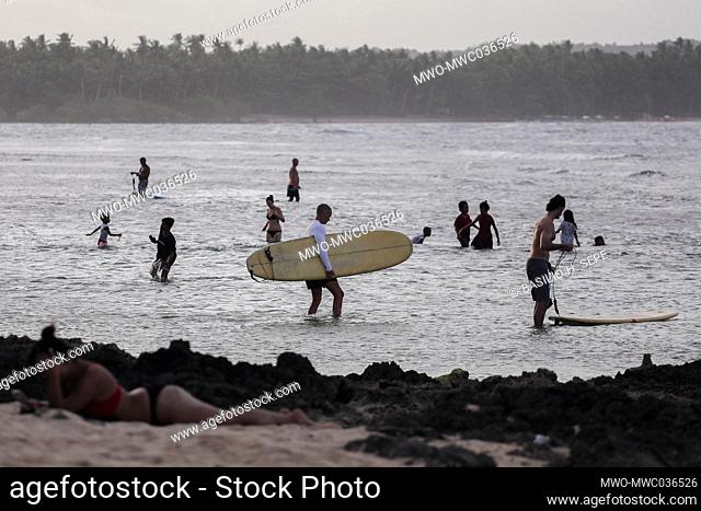 Tourists are seen along the shoreline in SIargao Island, Surigao del Norte province south of Manila, Philippines