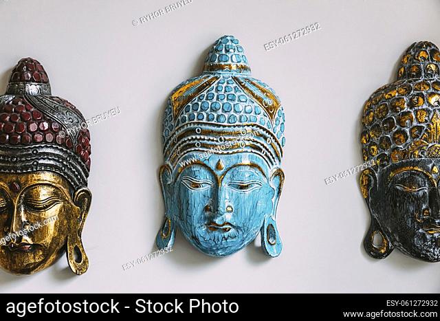 Close up of handmade souvenirs buddha mask on white background. Isolated on white. Details