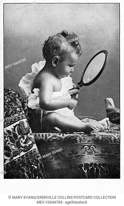 Baby boy sat on a fine Persian rug is amazed by his own reflection in a hand mirror. If one looks carefully, you can see that this photograph is (rather poorly)...