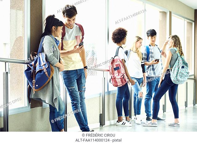 Students hanging out in school corridor between classes