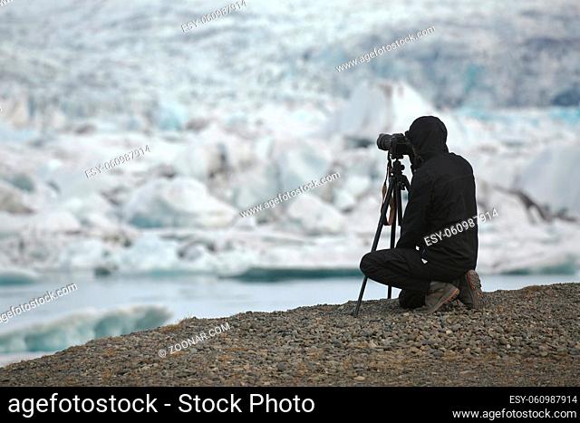 Photographer taking photos of a glacier in iceland