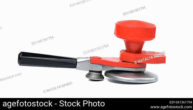 Manual metal seamer on a white isolated background, close up