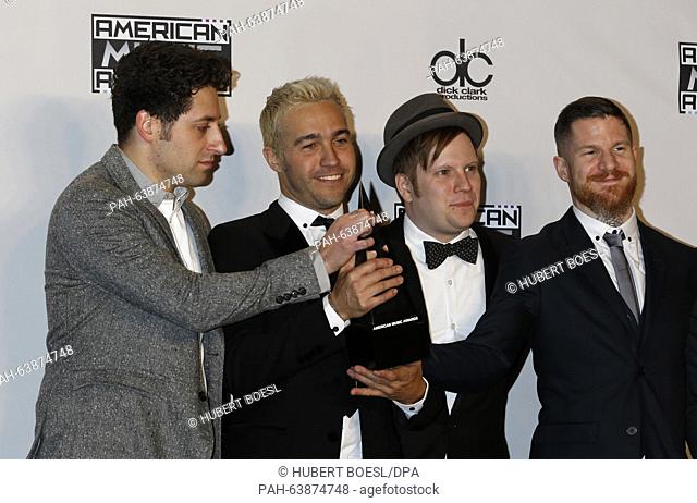 Joe Trohman (l-r), Pete Wentz, Patrick Stump, and Andy Hurley of Fall Out Boy pose in the pressroom of the 2015 American Music Awards, AMAs