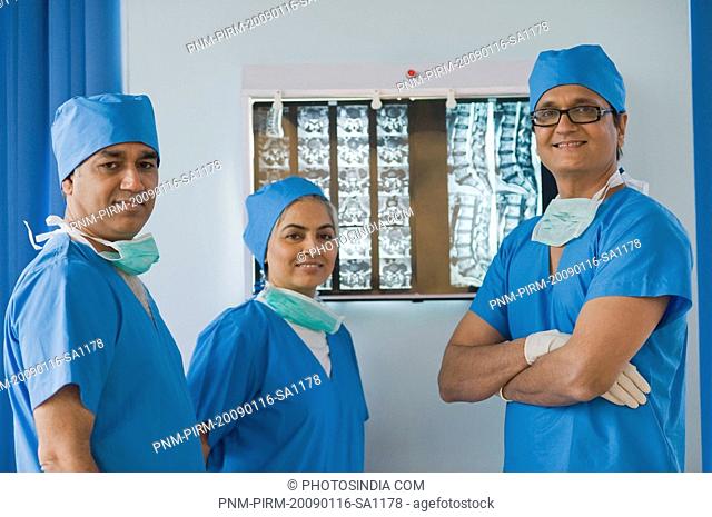 Three surgeons smiling in a hospital, Gurgaon, Haryana, India