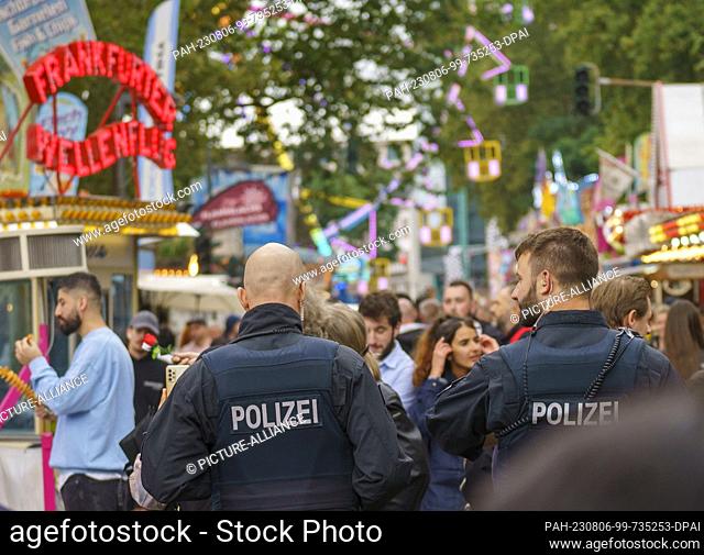 06 August 2023, Hesse, Frankfurt/Main: A police patrol walks the festival route. The Mainfest (04.08.-07.08.23) is one of the oldest public festivals in...