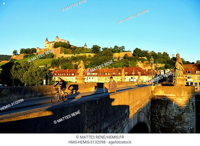 Germany, Bavaria, Upper Franconia Region, Wurzburg, Statue on Old Main Bridge (Alte Mainbrücke) and Fortress Marienberg
