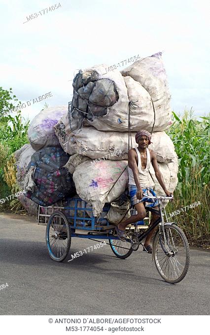 indian man transport big bags filled with plastic bottles on his rickshaw in dhapa district  kolkata  west bengal  india  asia