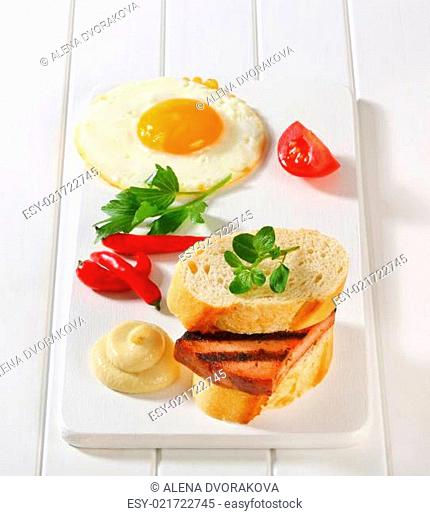 Grilled Leberkase sandwich with mustard and fried egg