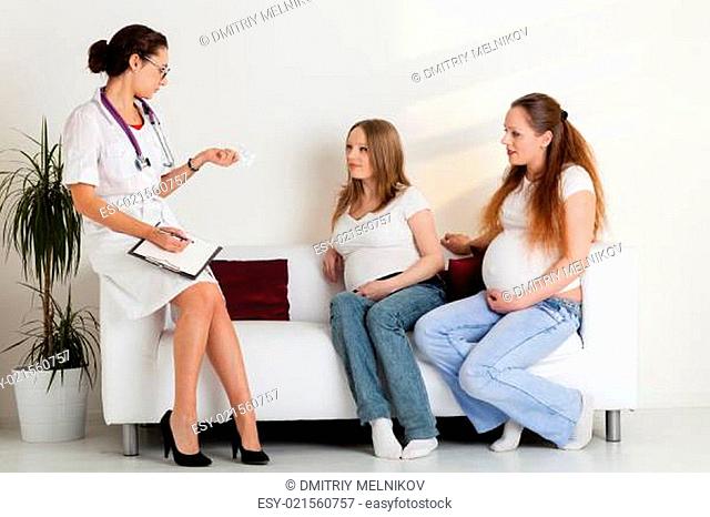 Two pregnant women and doctor