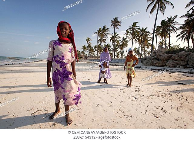 Young Muslim girls with colorful clothing playing at the beach, Jambiani, Zanzibar Island, Tanzania, Indian Ocean, East Africa