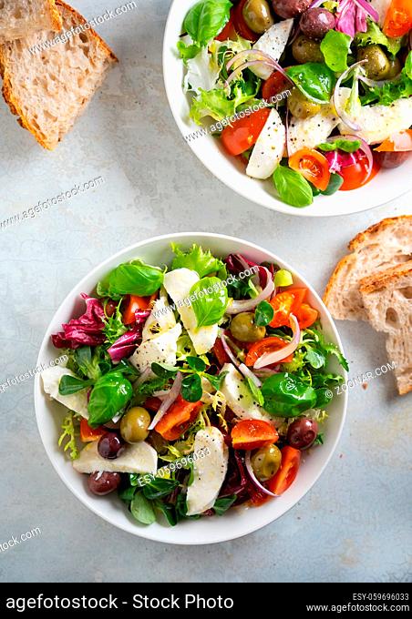 Fresh green salad with cherry tomato, mozzarella and olives. . High quality photo