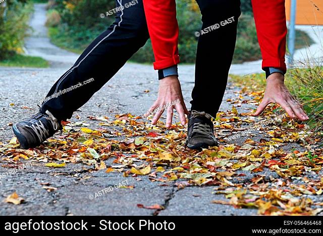 Danger of slipping in autumn and winter. A woman slipped on wet, smooth leaves