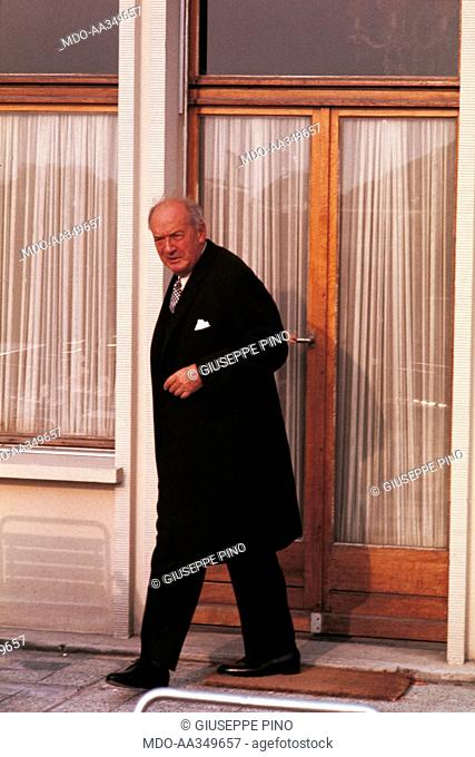 Vladimir Nabokov in front of a hotel . Russian-born American writer Vladimir Nabokov coming out of a hotel in Montreux, where he lives