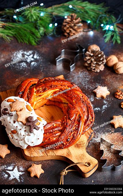 Sweet Bread Wreath decorated with stars cookies. Honey brioche garland with chocolate and nuts. Holiday recipes. Braided Bread