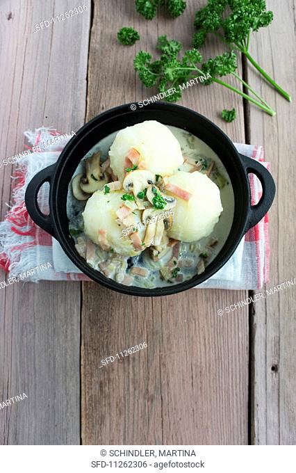 Potato dumplings with a mushroom and bacon sauce