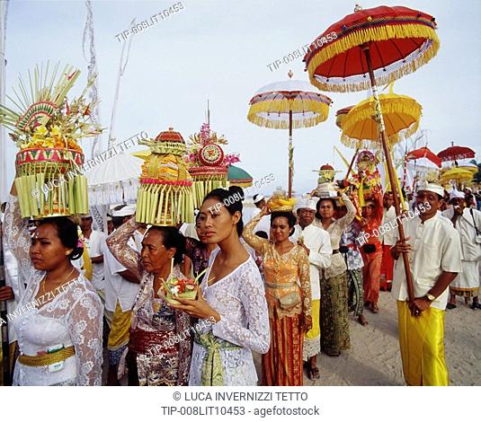 Balinese girl with offering during a ceremony, Bali, Indonesia