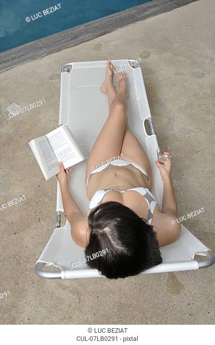 Woman reading a book, overhead view