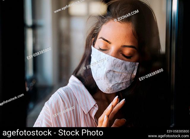 dark skinned arabic Middle East woman wearing DIY face mask protective against virus or bacteria. concept photo for social distancing and its consequences like...