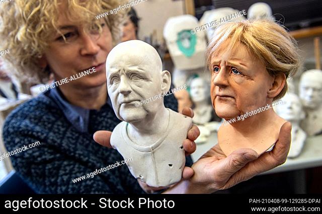 08 April 2021, Saxony, Lichtenstein: In her workshop in Lichtenstein, Brigitte Schneider is busy working on portrait heads depicting German Chancellor Angela...