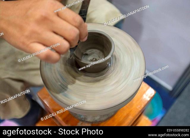 Concept Ceramic workshop. The man Throwing clay bowl on a pottery's wheel