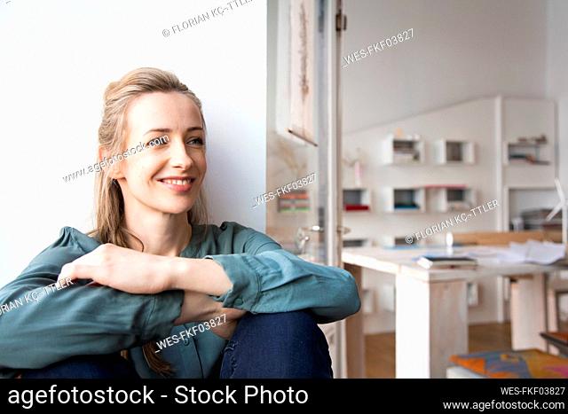 Smiling woman having a break in home office