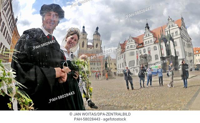 This year's Luther couple Maria Jana Palaschevsky as Katharina von Bora and Fred Goede as Martin Luther are mirrored in a reflecting globe in front of the town...