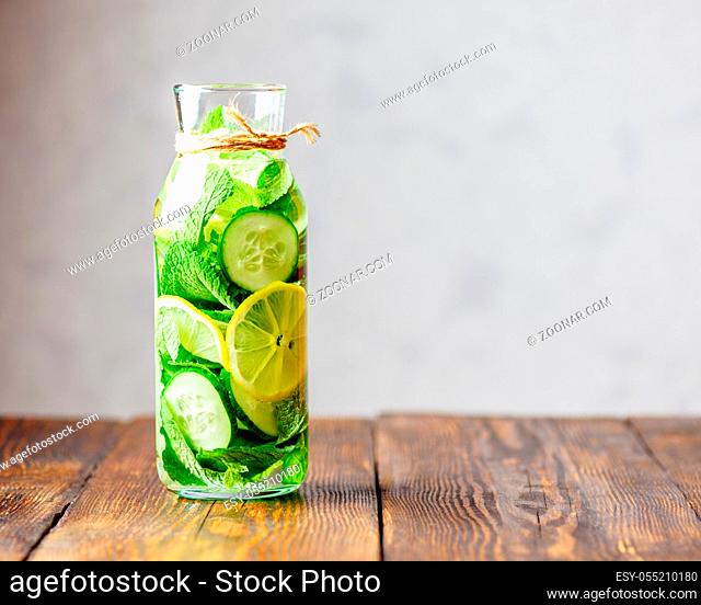 Detox Water Infused with Sliced Lemon, Cucumber and Sprigs of Mint. Copy Space on the Right