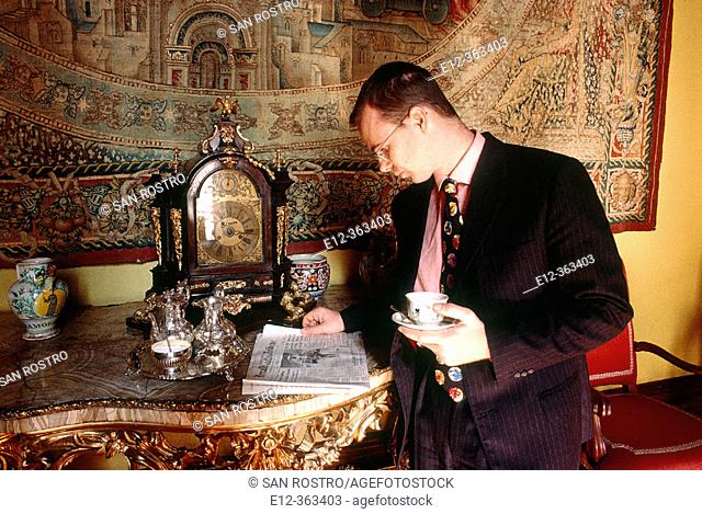 Prince Jonathan Doria Pamphilj reading news at breakfast. Rome. Italy