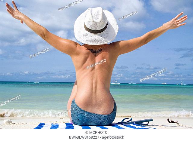 woman with sun hat enjoys the beach holiday, Philippines