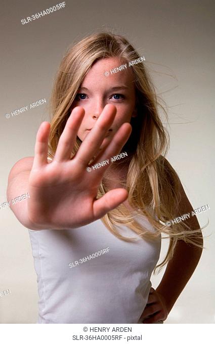 Teenage girl making stop gesture