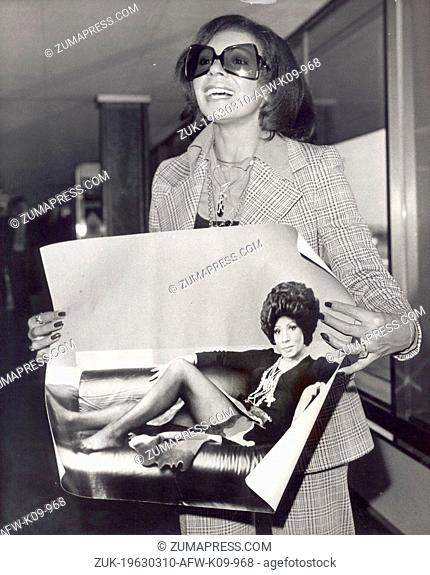 Mar. 10, 1963 - London, England, U.K. - Singer SHIRLEY BASSEY shows off picture by Lord Snowdon upon arrival at Heathrow Airport