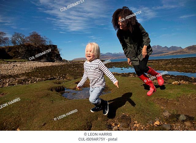 Mother and son running on grass