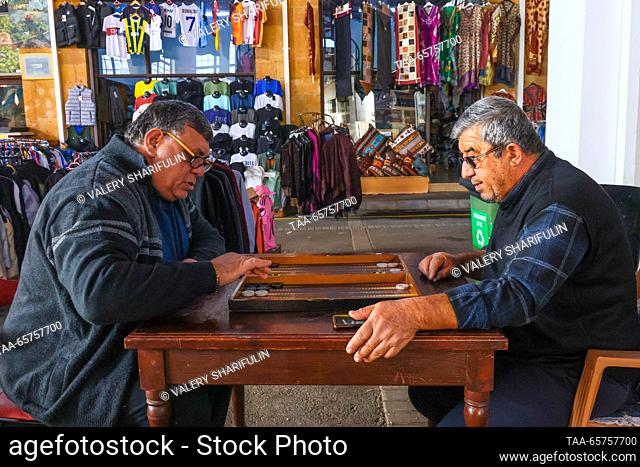 CYPRUS, NICOSIA - DECEMBER 14, 2023: Men play backgammon at the Old Market. The Turkish Republic of Northern Cyprus is a de facto state declared independent by...