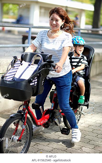 Japanese mother and kid riding a bike