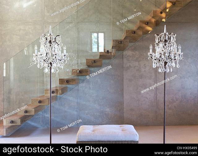 Home showcase interior chandelier lamps in front of modern floating staircase