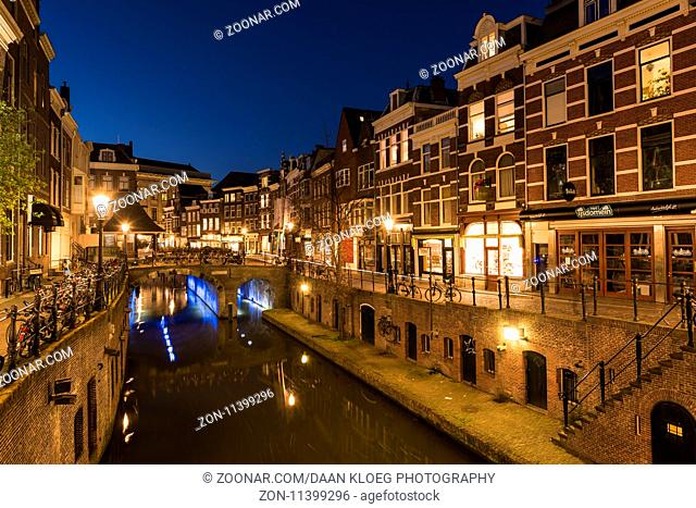 Utrecht, The Netherlands - March 27, 2017: Vismarkt at night with bikes, canal, restaurants and monumental houses