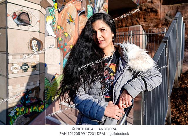 05 December 2019, Rhineland-Palatinate, Pirmasens: The artist Isidora Paz Lopez stands in front of a mosaic wall during the presentation of the probably largest...