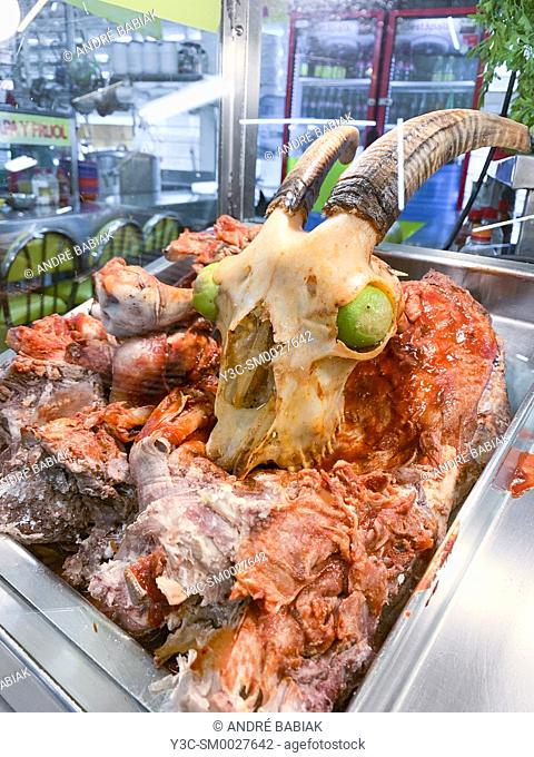 Goat skull and meat on display at a local market in Guadalajara, Jalisco, Mexico. Goat meat is the main ingredient of Birria - a traditional stew home to...