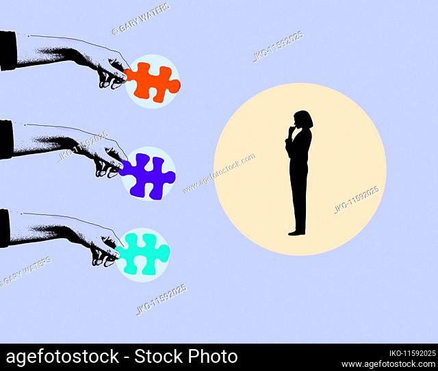 Woman choosing between different jigsaw puzzle pieces