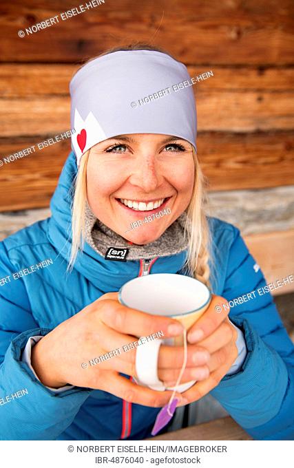 Female skier at the tea break at the hut, Hohe Salve, Hopfgarten, Tyrol, Austria