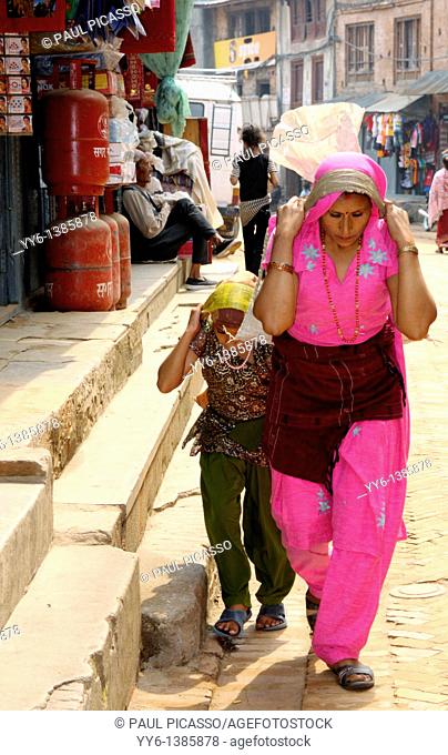 hardworking nepalese women and child carrying heavy load, the nepalis , life in kathmandu , kathmandu street life , nepal