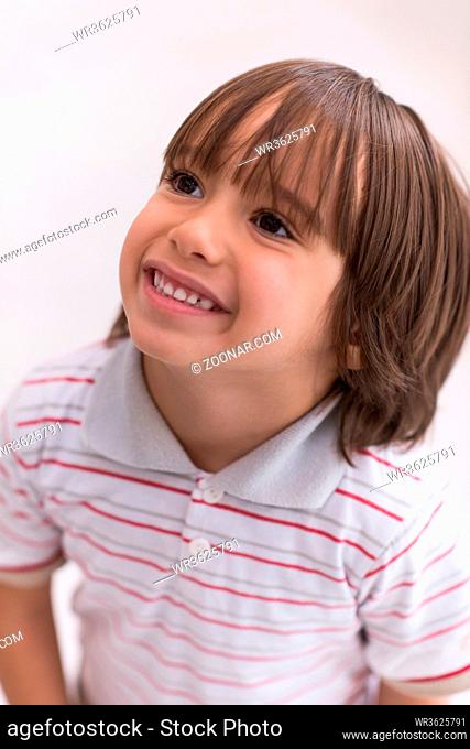 Portrait of happy joyful beautiful little boy who looking up isolated on white background