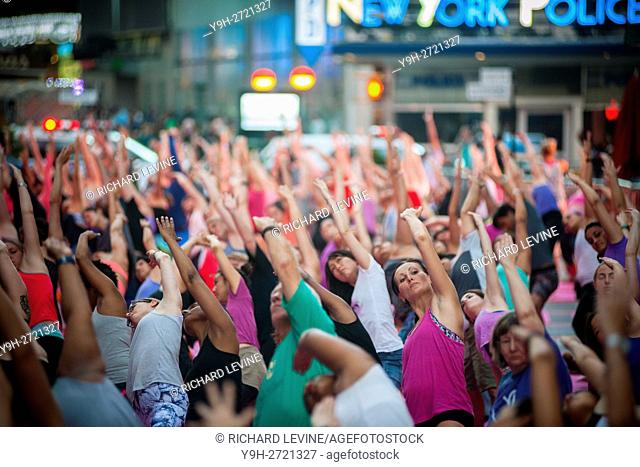 Thousands of yoga practitioners pack Times Square in New York to practice yoga on the first day of summer. The 14th annual Solstice in Times Square