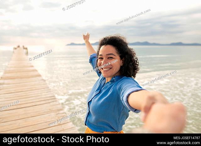 Couple holding hands on jetty
