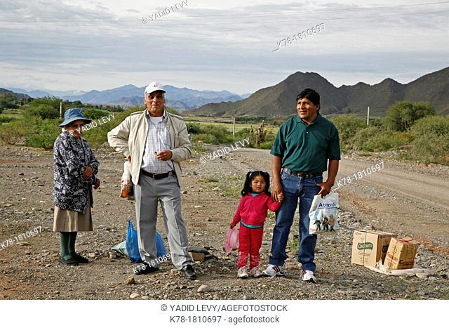 Quechua family standing on the road a few miles away from Cachi in valles Calchaquies, Salta Province, Argentina
