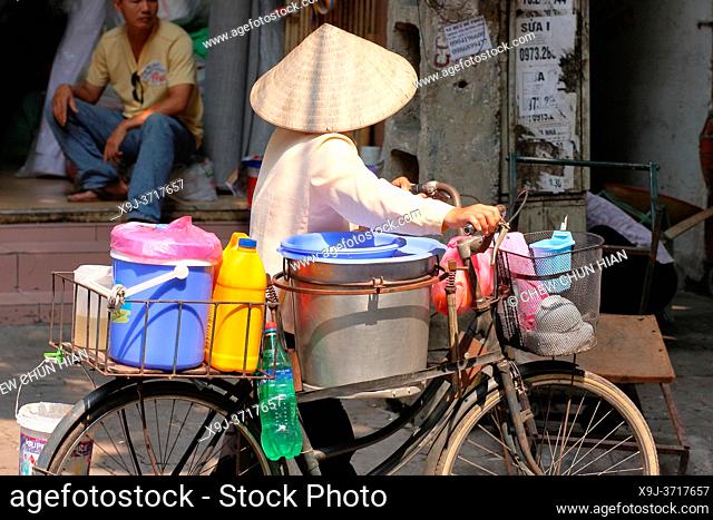 Female street vendor selling various thingsl, Dong Da District, Hanoi, Vietnam