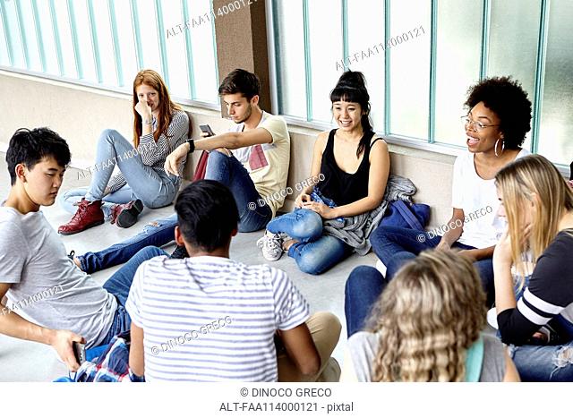 Group of students hanging out together in corridor